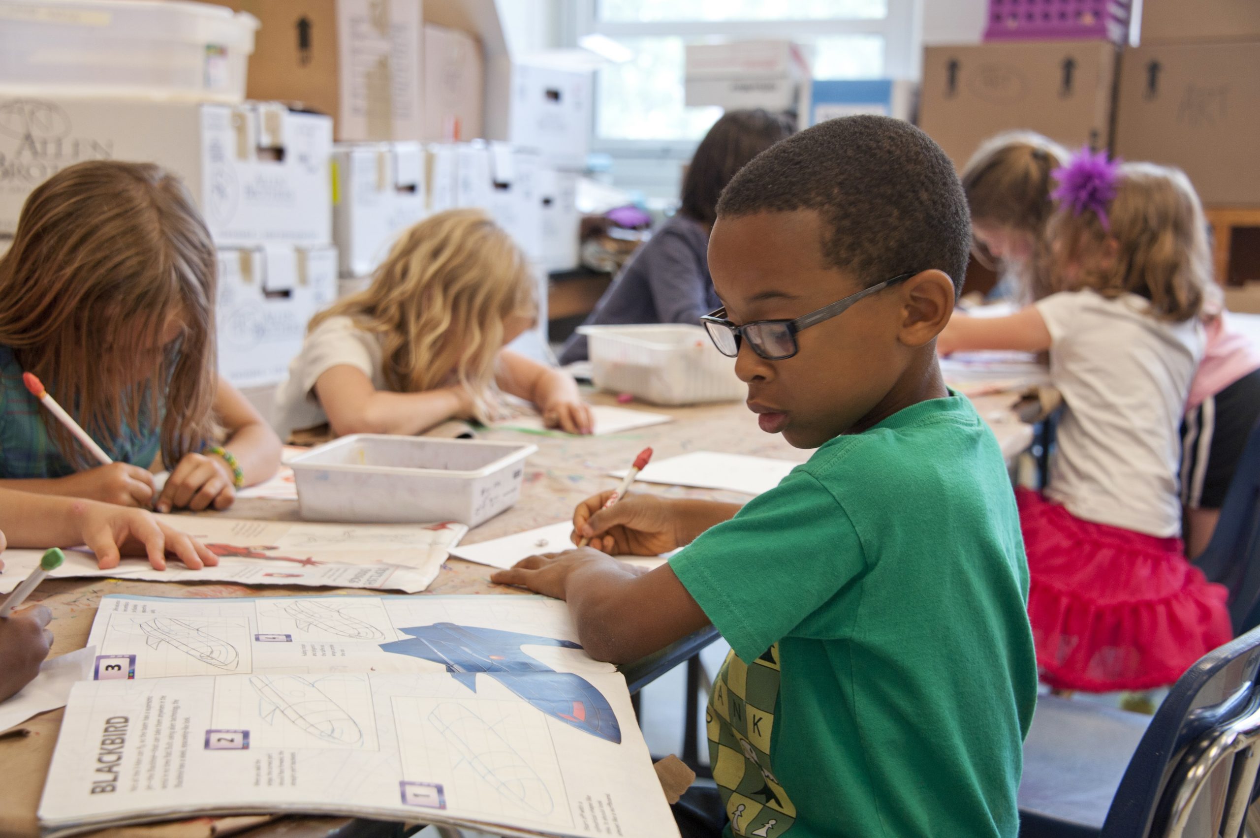 students working at a table in school