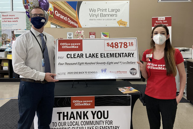 Two people holding a giant check.