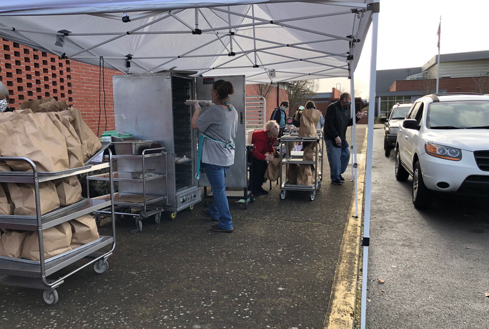 Meals being served in a drive thru.