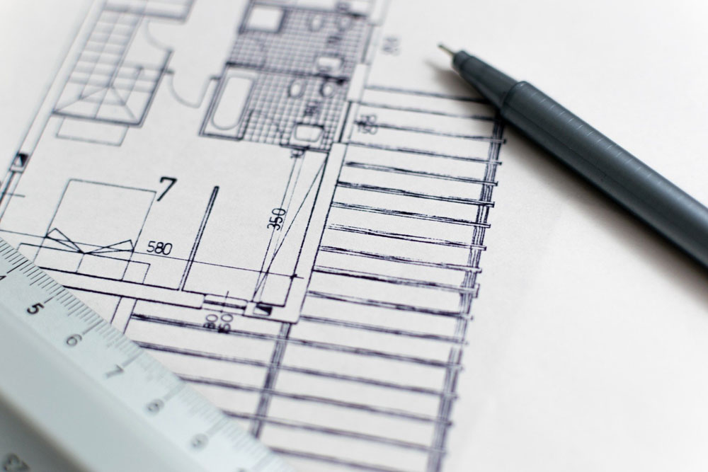 architectural drawing with a pen on it