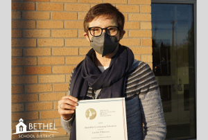 person holding an award certificate