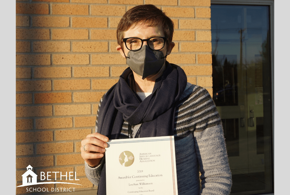 person holding an award certificate