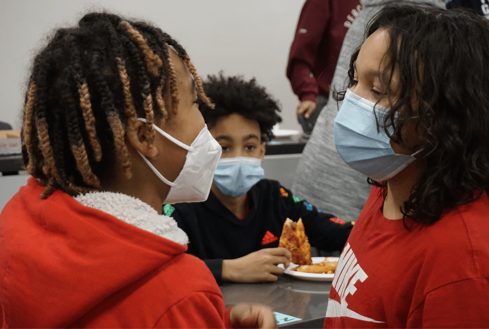 three students wearing masks