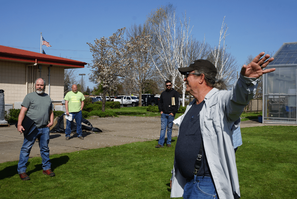 Pat Bradshaw pointing at space behind Kalapuya High