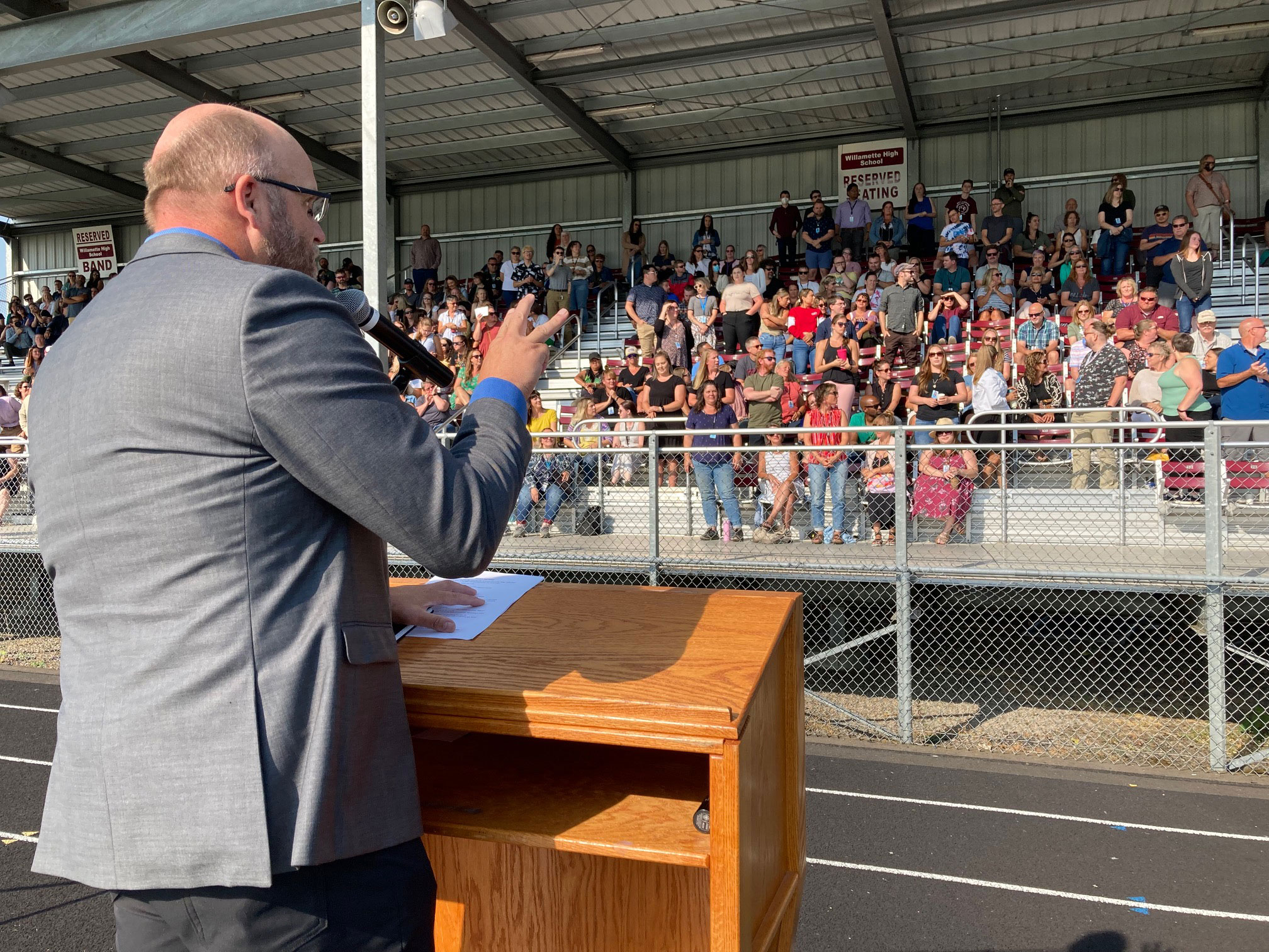 Superintendent Sproles talking to a crowd of people at the WHS stadium