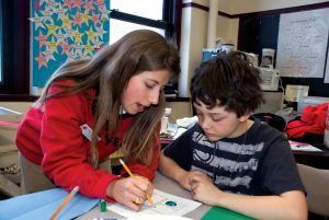 volunteer helping a student