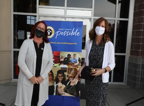 Christy Smith Receives Golden Apple Award from Board Vice President Maria Greeley. 