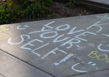 This is the image for the news article titled Boise Students and Boise State Athletes 'Chalk the Walk' to Kick Off National Suicide Prevention Month with Messages of Hope and Support