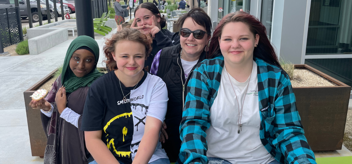 Ms. Jarvis smiles surrounded by playful students.