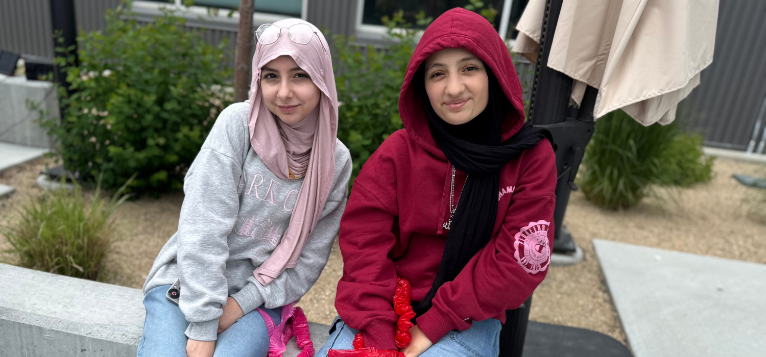 Two middle school students smile for the camera.