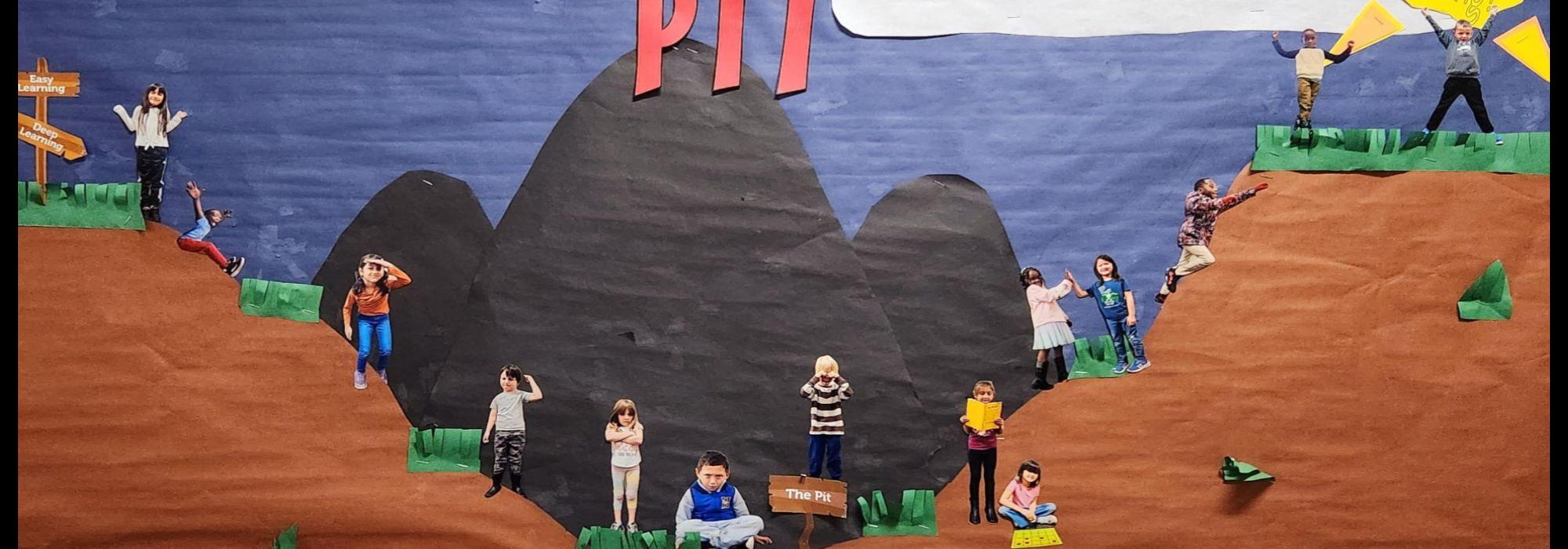 1st grade student photos on a learning pit bulletin board