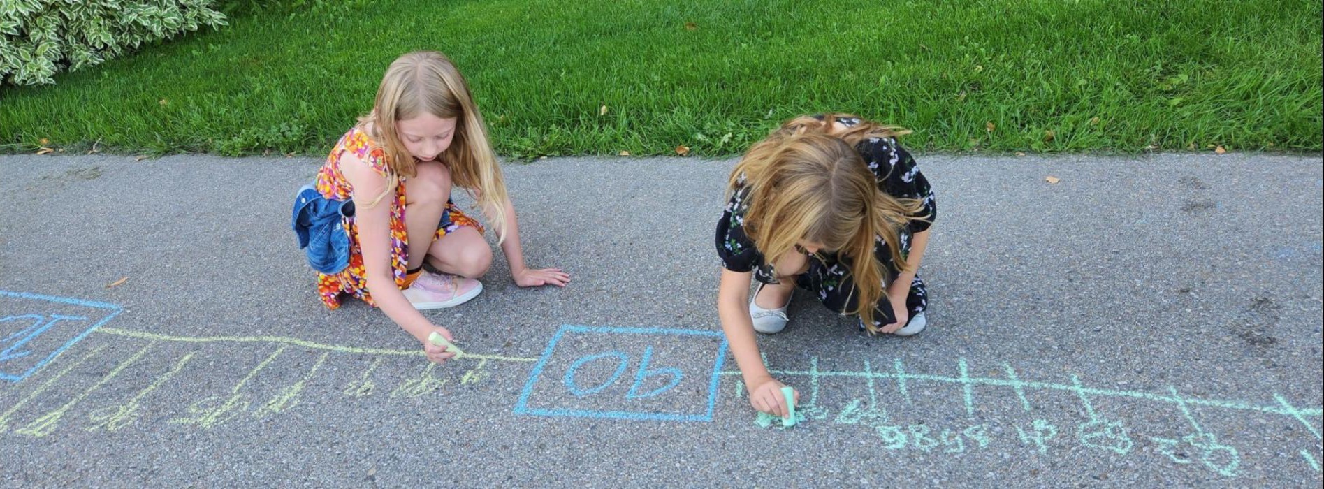 3rd grade girls making a chalk number line