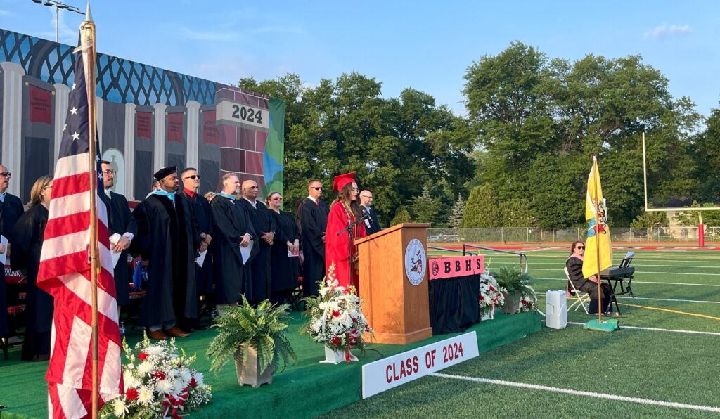 A photo of a graduate delivering the welcome remarks at the graduation ceremony.