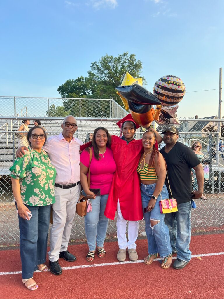 A family poses with their graduate after the ceremony.