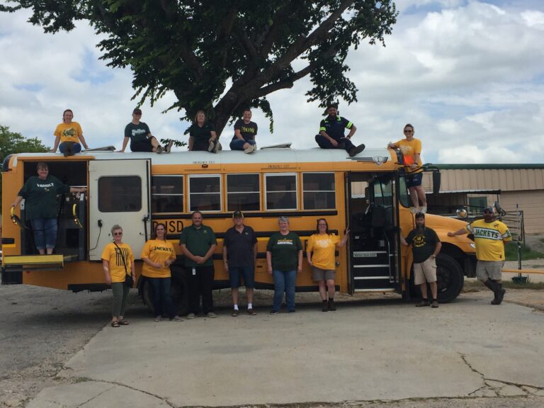 Photo of staff sitting on a schoolbus