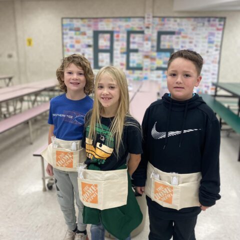 photo of elementary students with home depot aprons