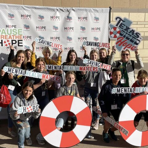 photo of hope squad members with #hope #savinglives #mentalhealthmatters signs