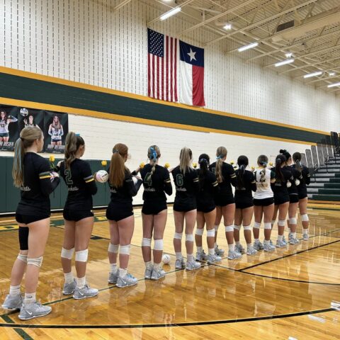 Photo of the girls volleyball team during the national anthem