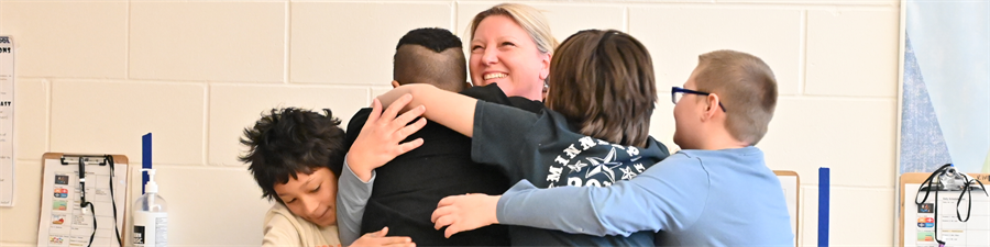 Teacher of the Year, Jeannne Kilian receives hug from her students