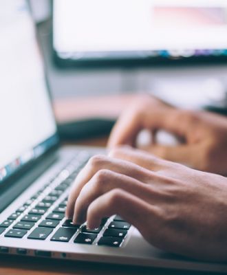  Hands typing on a keyboard