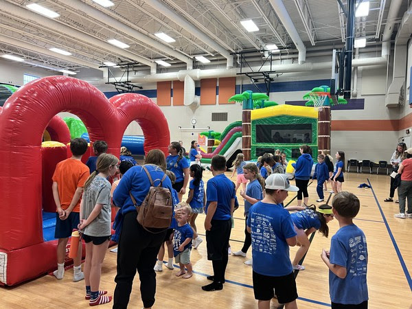 students waiting for bounce house