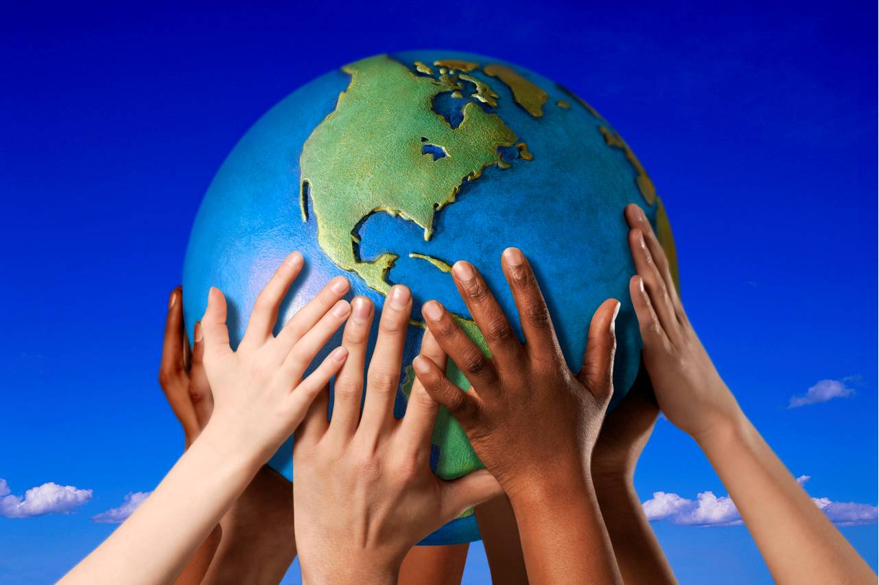 multicultural hands holding up a globe