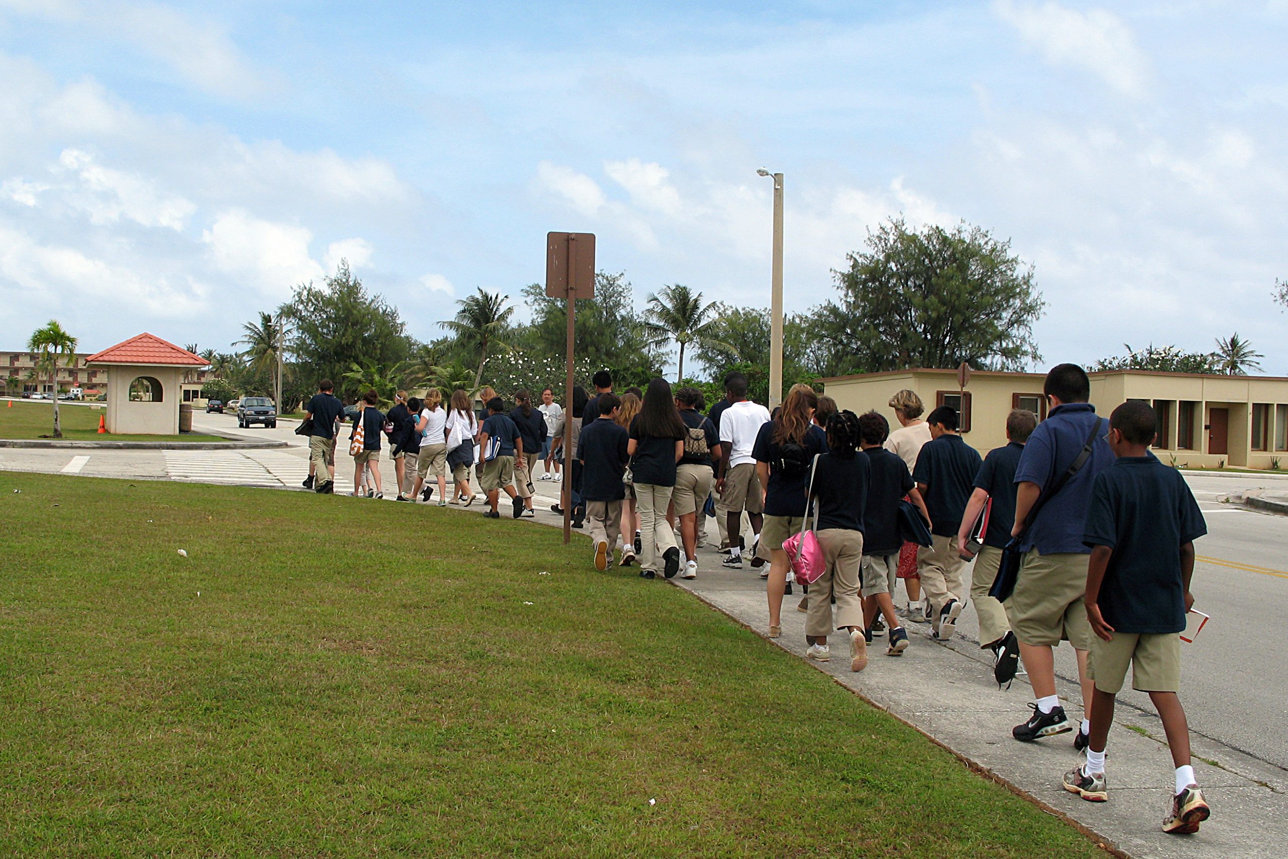 line of students walking down the sidewalk