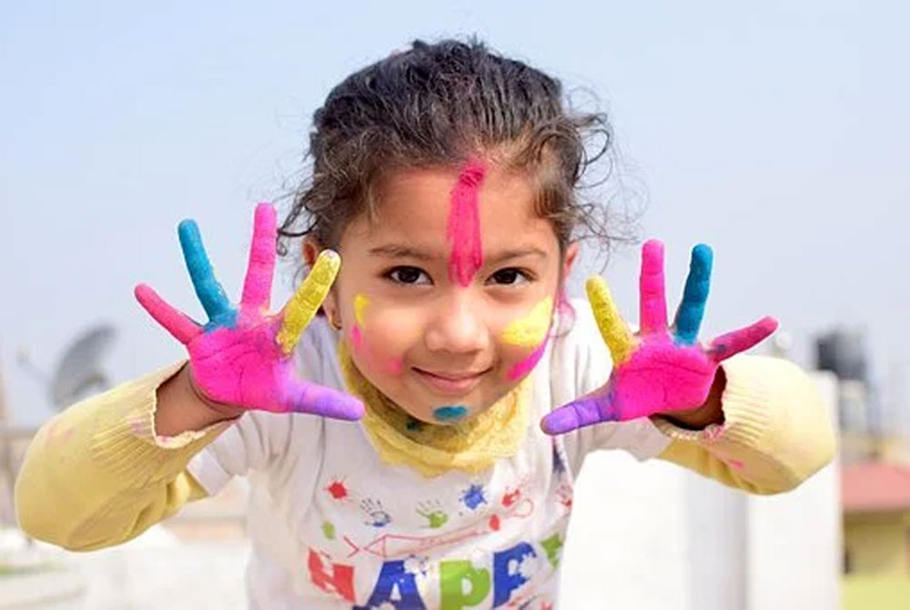 Child with painted hands and face