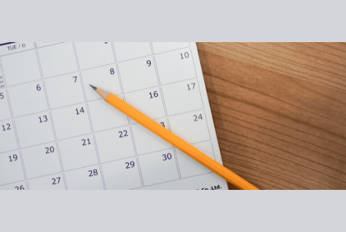 Calendar with pencil laying on it