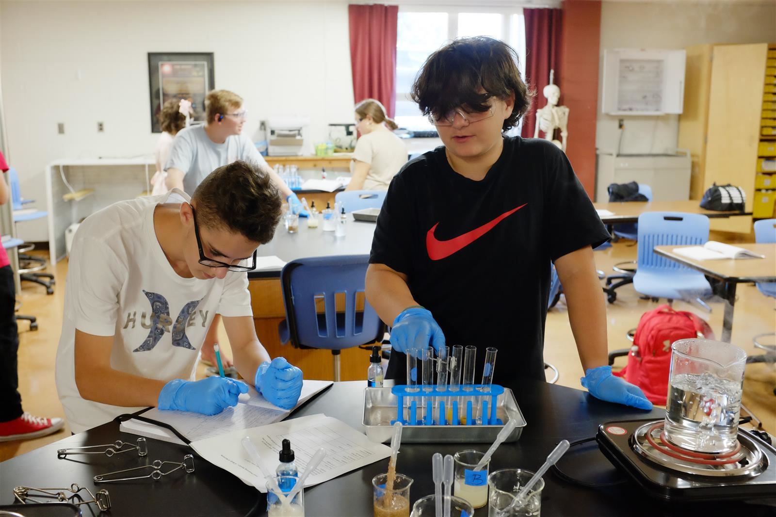  two students working on a science experiment