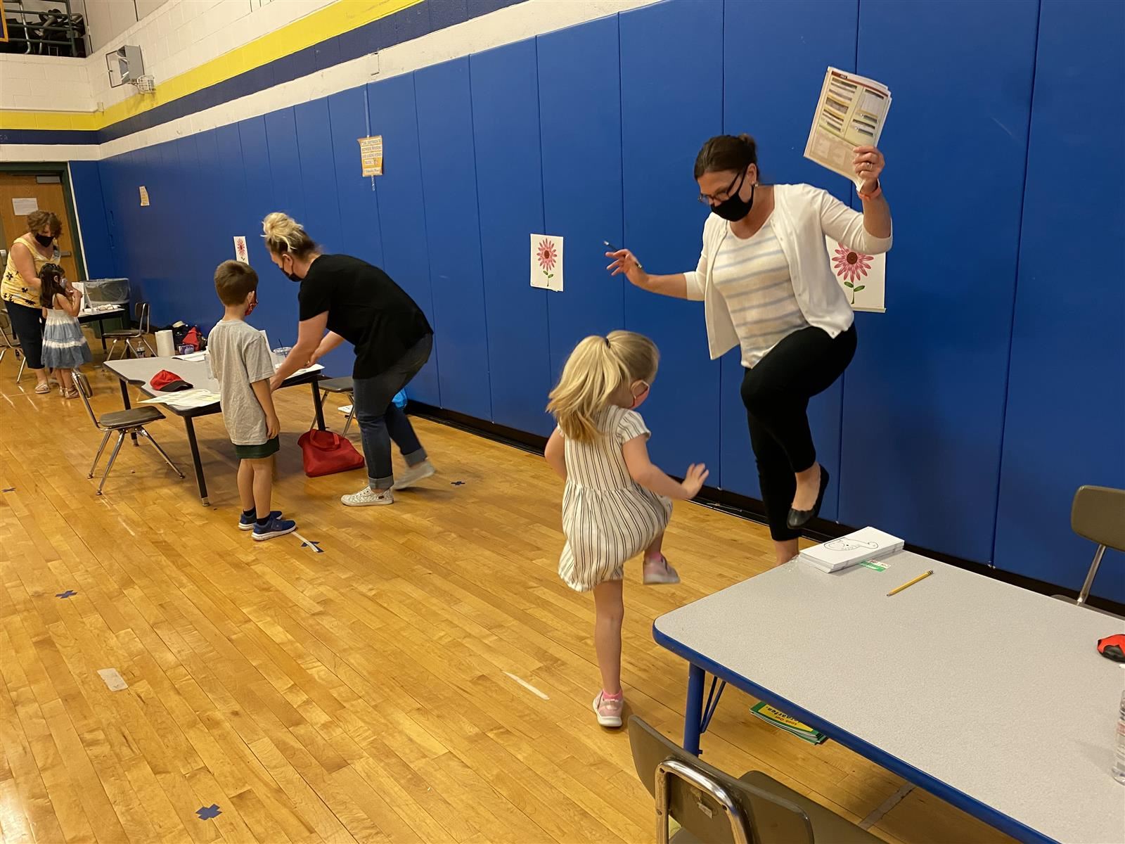 teachers giving kinder screening to students