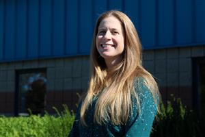  A woman posing for the camera outside, in front of a building
