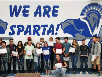 A group of students in front of a We Are Sparta! sign