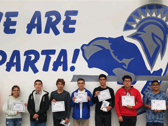 A group of students in front of a We Are Sparta! sign