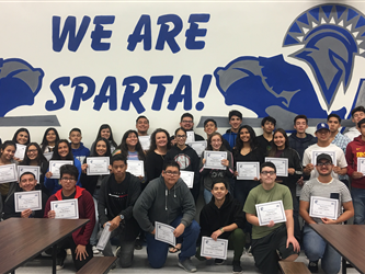 A group of students in front of a We Are Sparta! sign