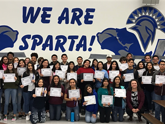 A group of students in front of a We Are Sparta! sign