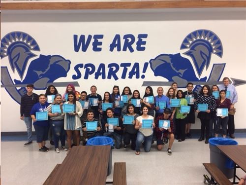 students holding awards in the cafeteria