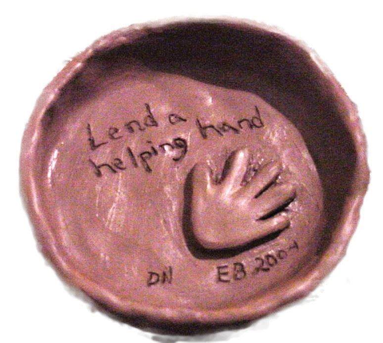 Bowl with "lend a helping hand" written in center