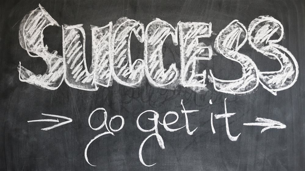 Success and go get it written on a chalk board.