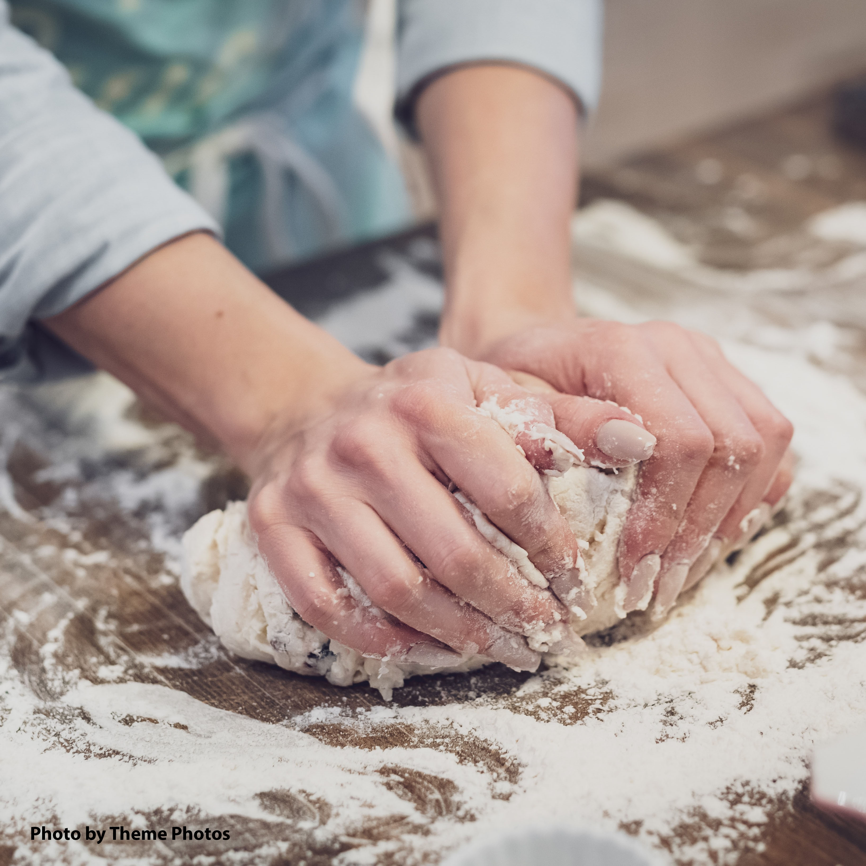 student kneading dough