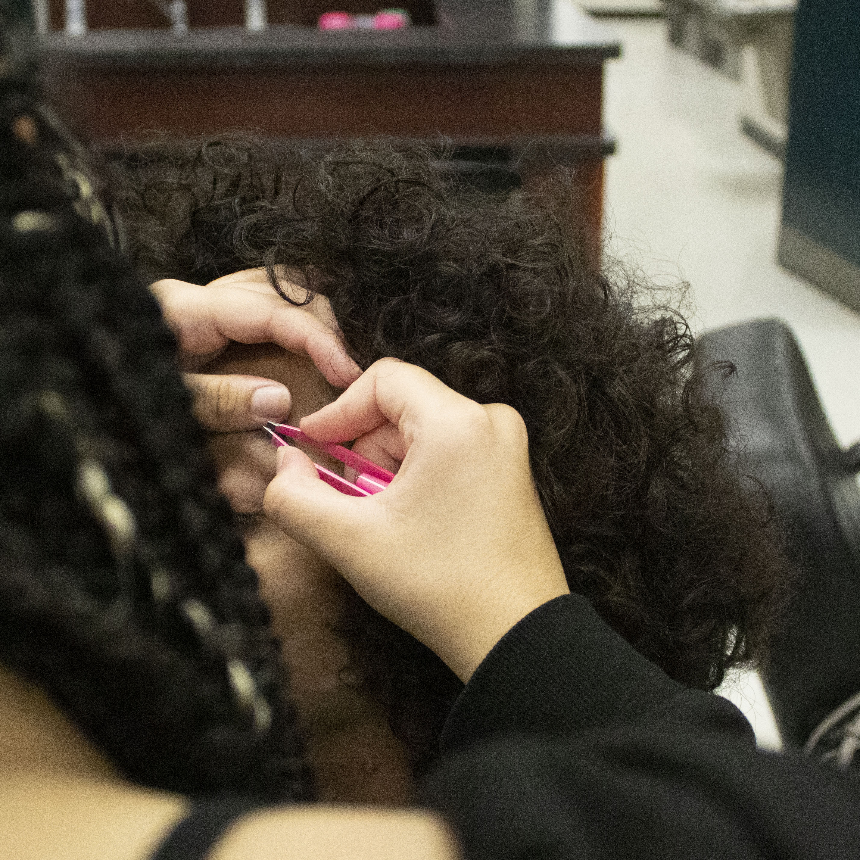 student styling a client's eyebrows in the CTC salon