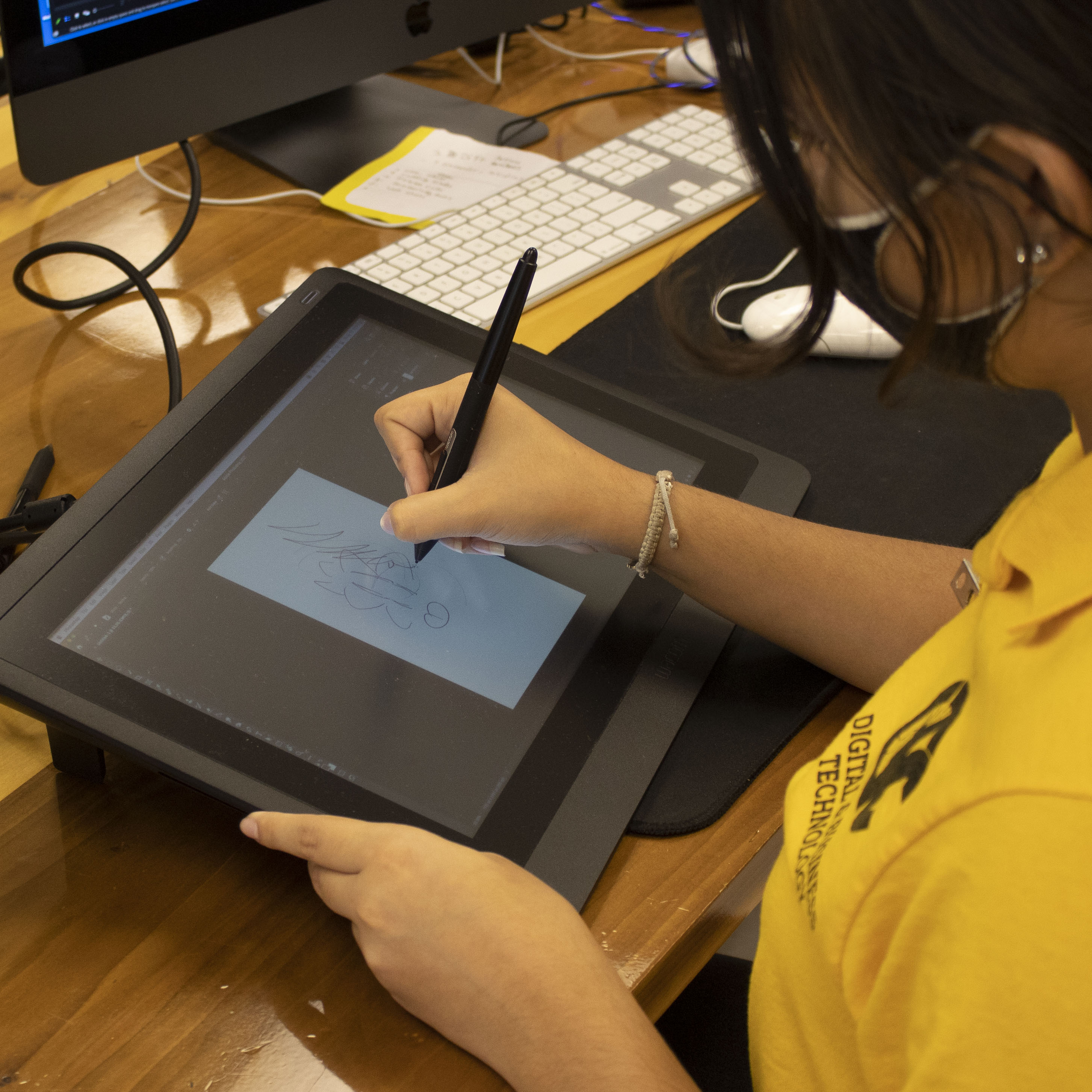 student working on screened drawing tablet