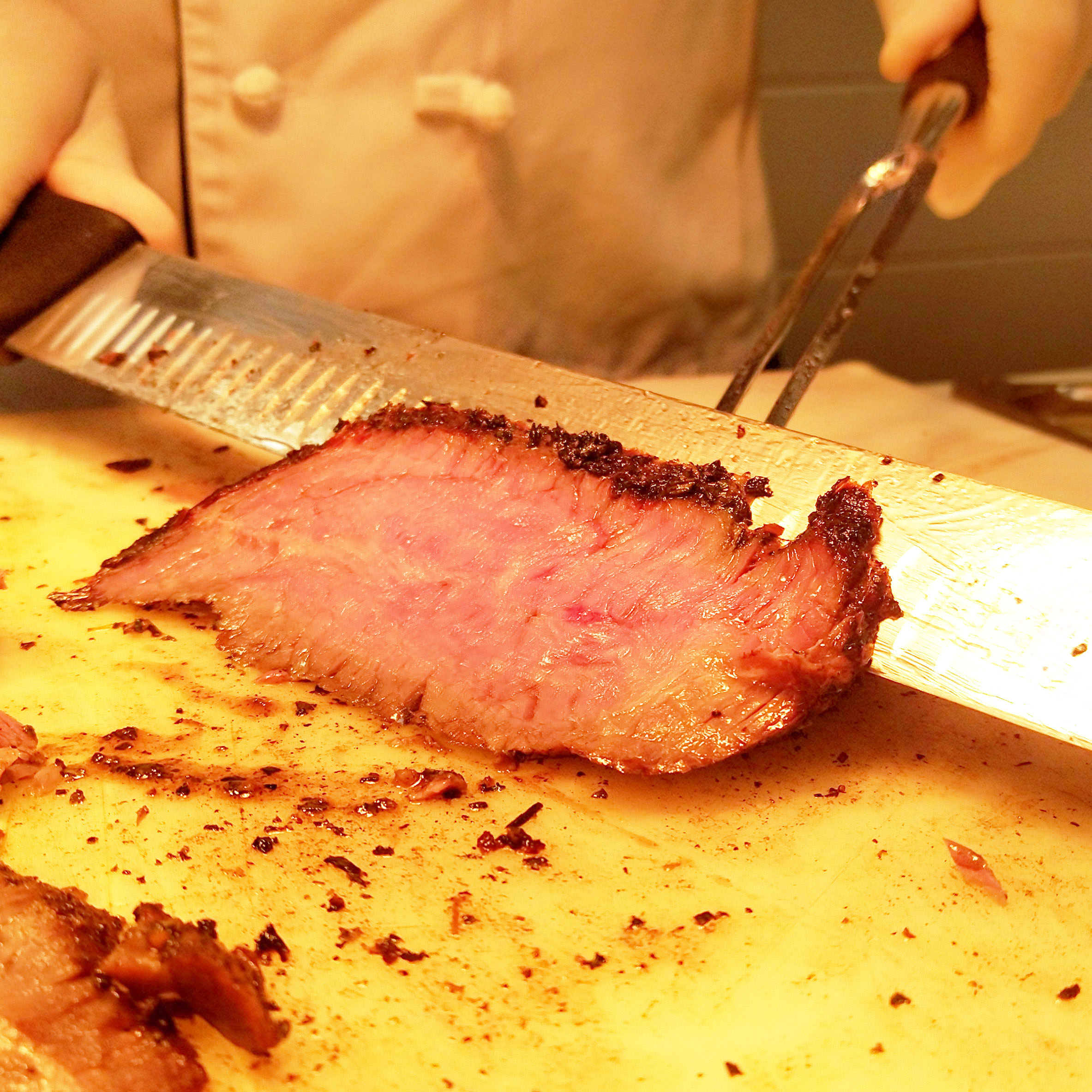 student slicing meat in Papa G's at CTC