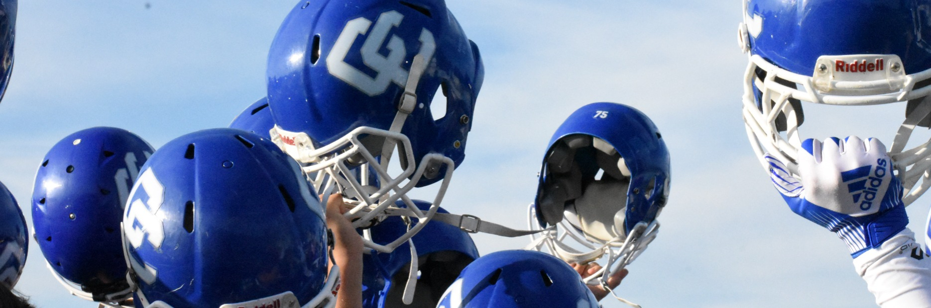 Football Helmets Raised in the air
