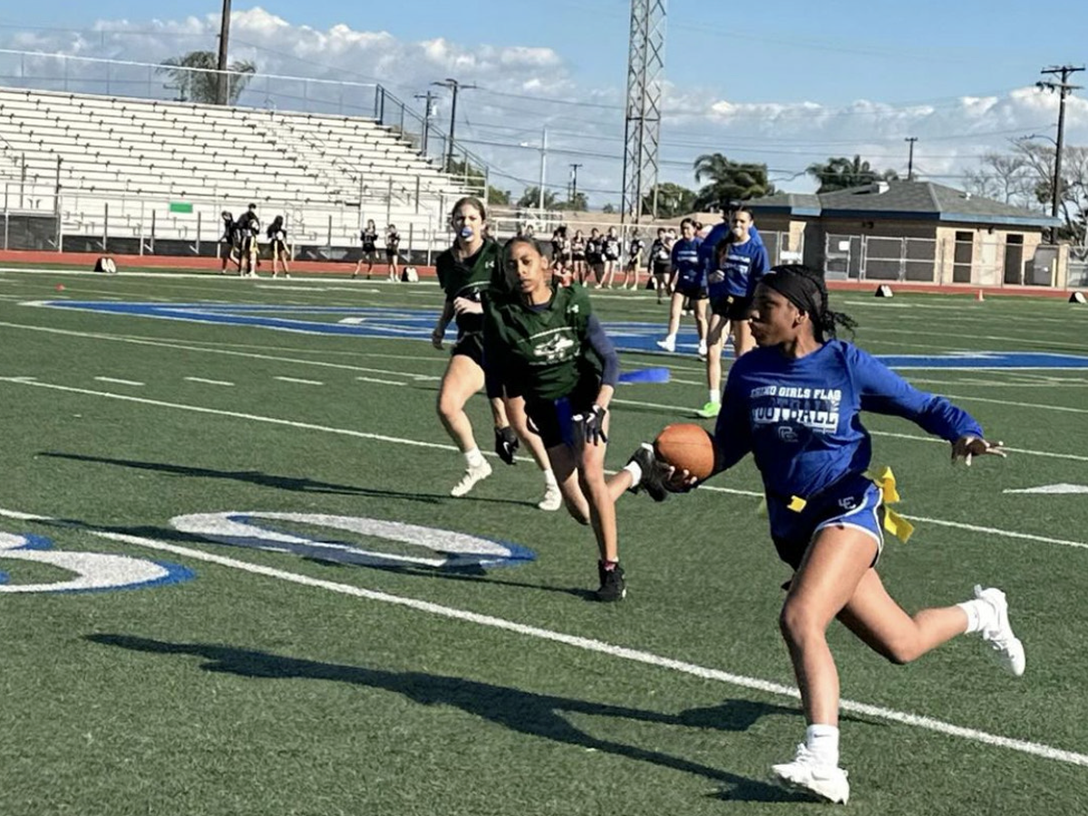 A Chino high flag football player evading Chino Hills High players