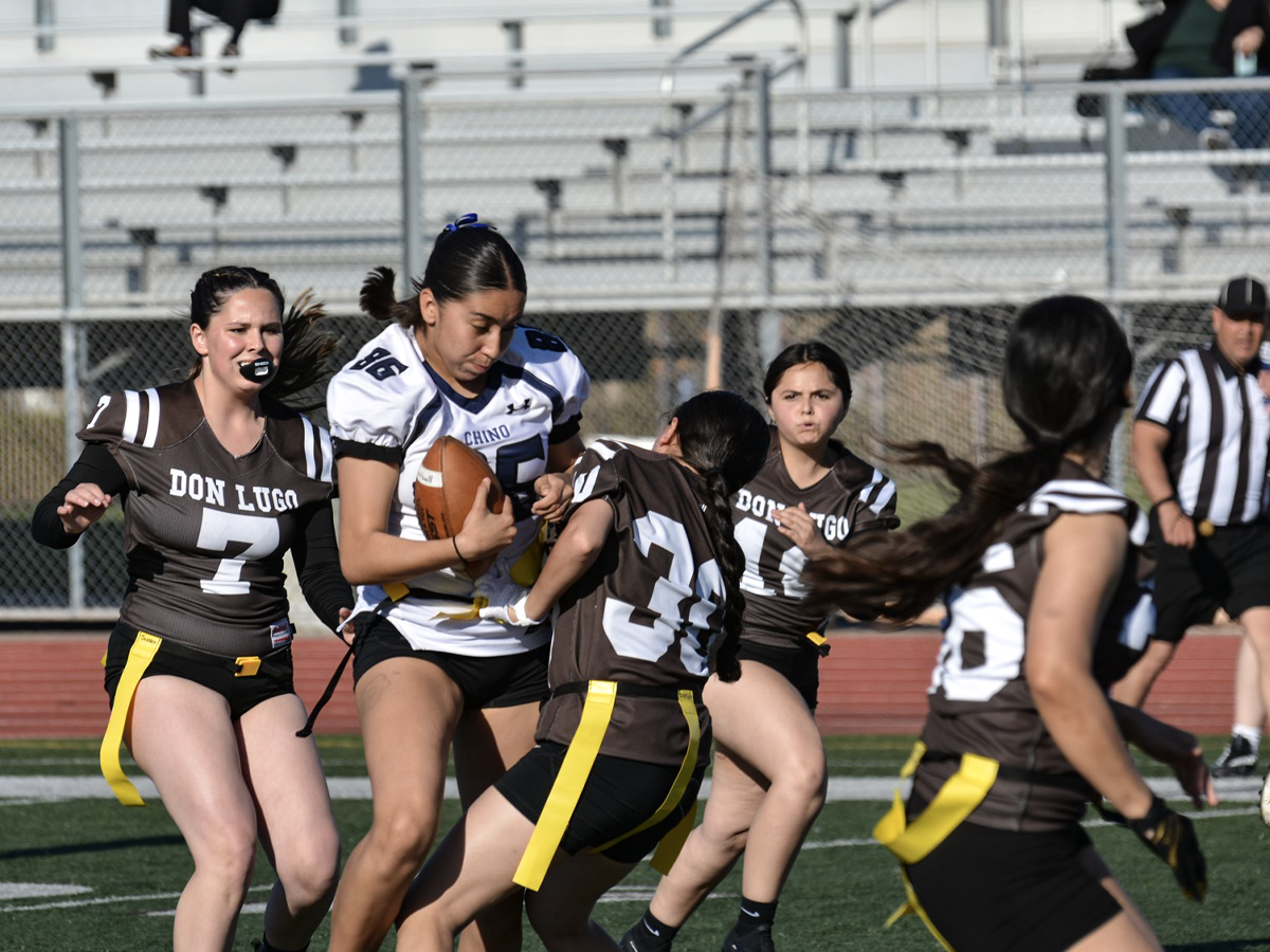 A Chino high flag football player attempting to dodge Don Lugo players