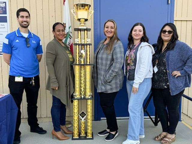 Briggs receiving the attendance award trophy