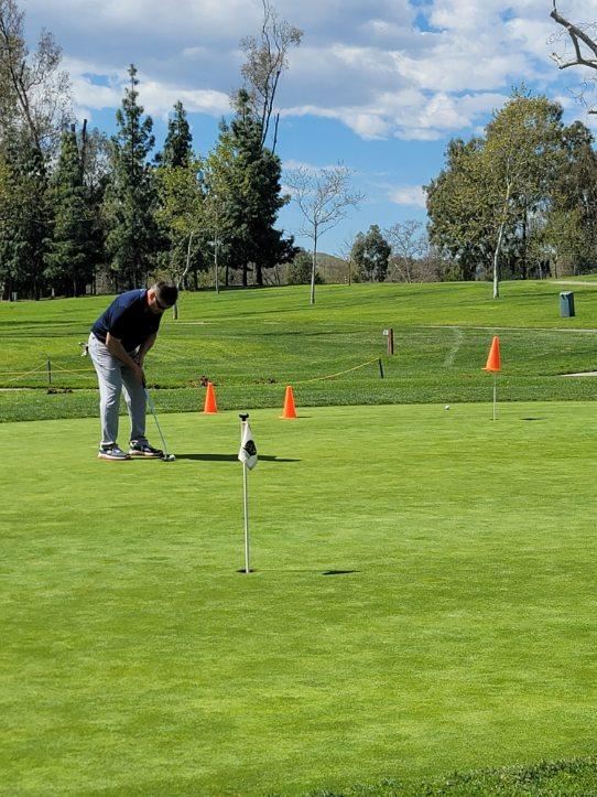 golfer putting the ball