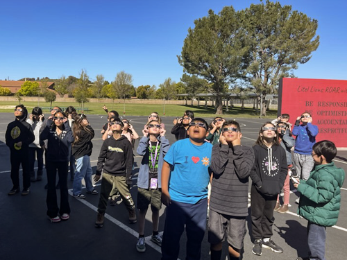 Students looking up at the sky to view the solar eclipse
