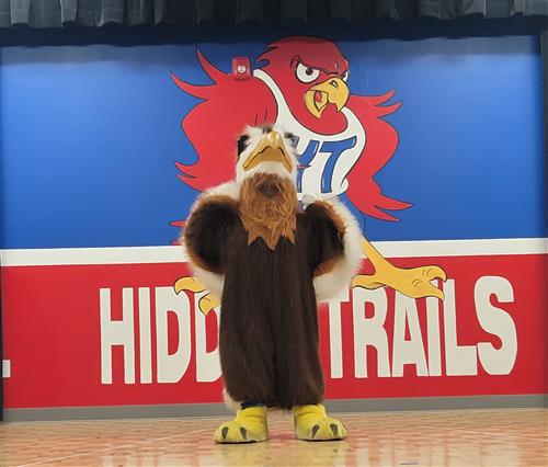 Hidden Trails Red Hawk Mascot posing on MPR stage